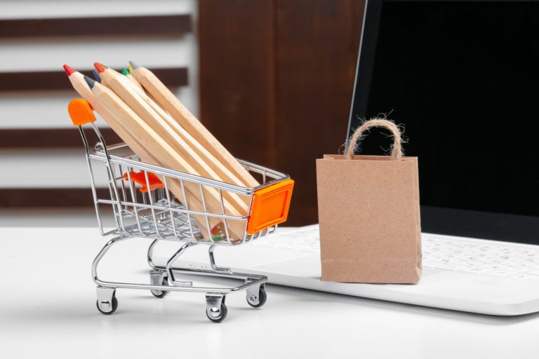 a shopping cart with a cardboard box