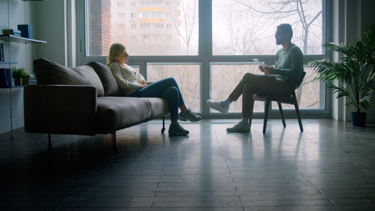 a couple of people sitting on a couch in a room