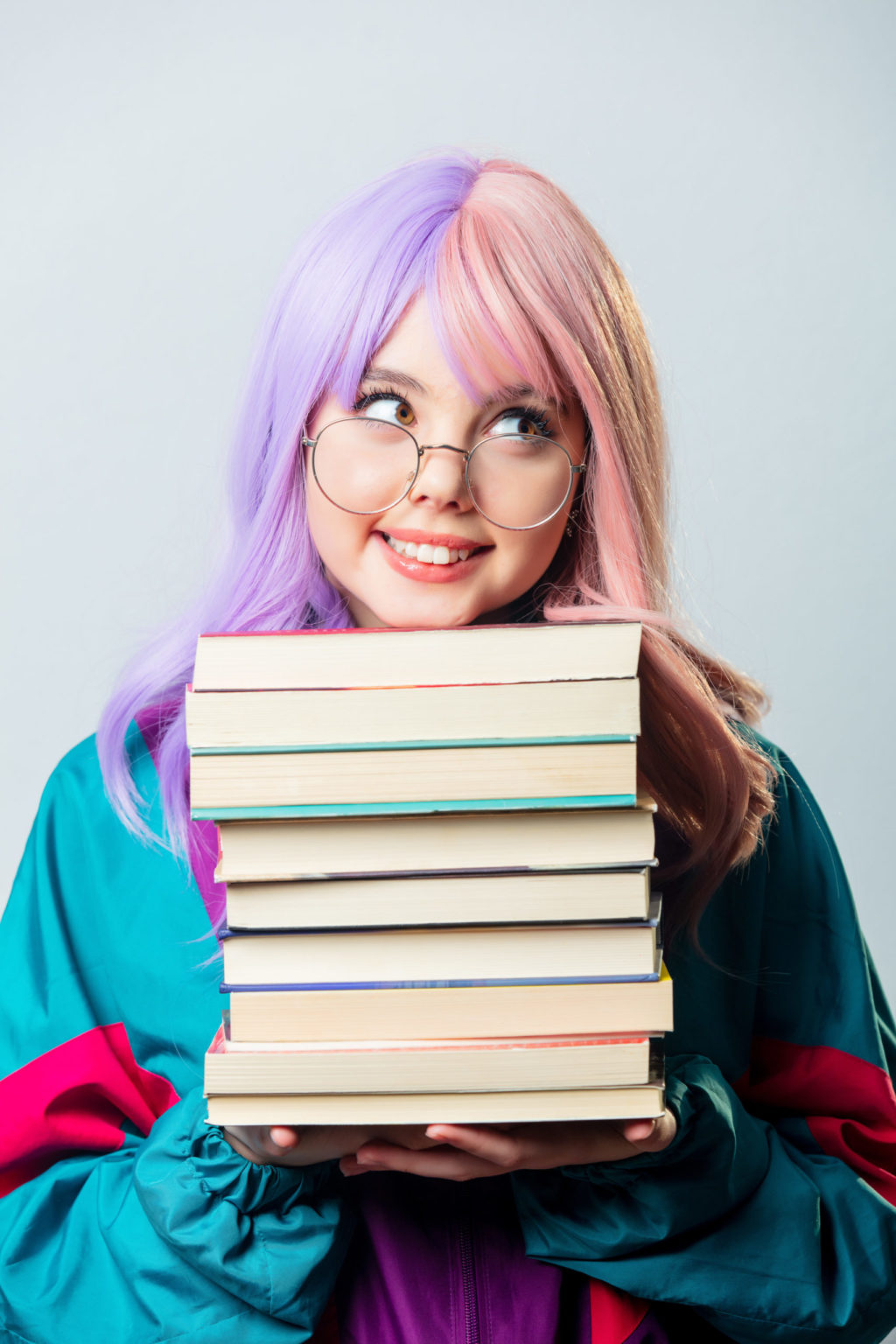 a person holding a stack of books