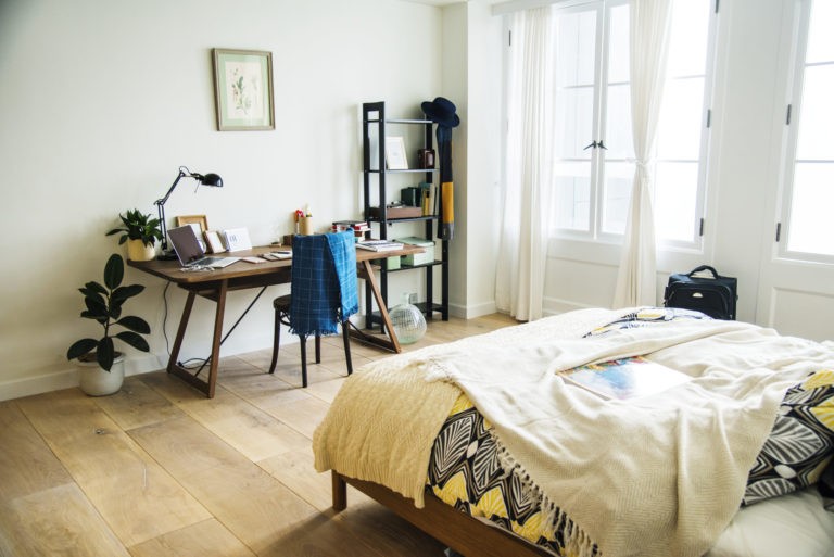 a bedroom with a bed and a desk