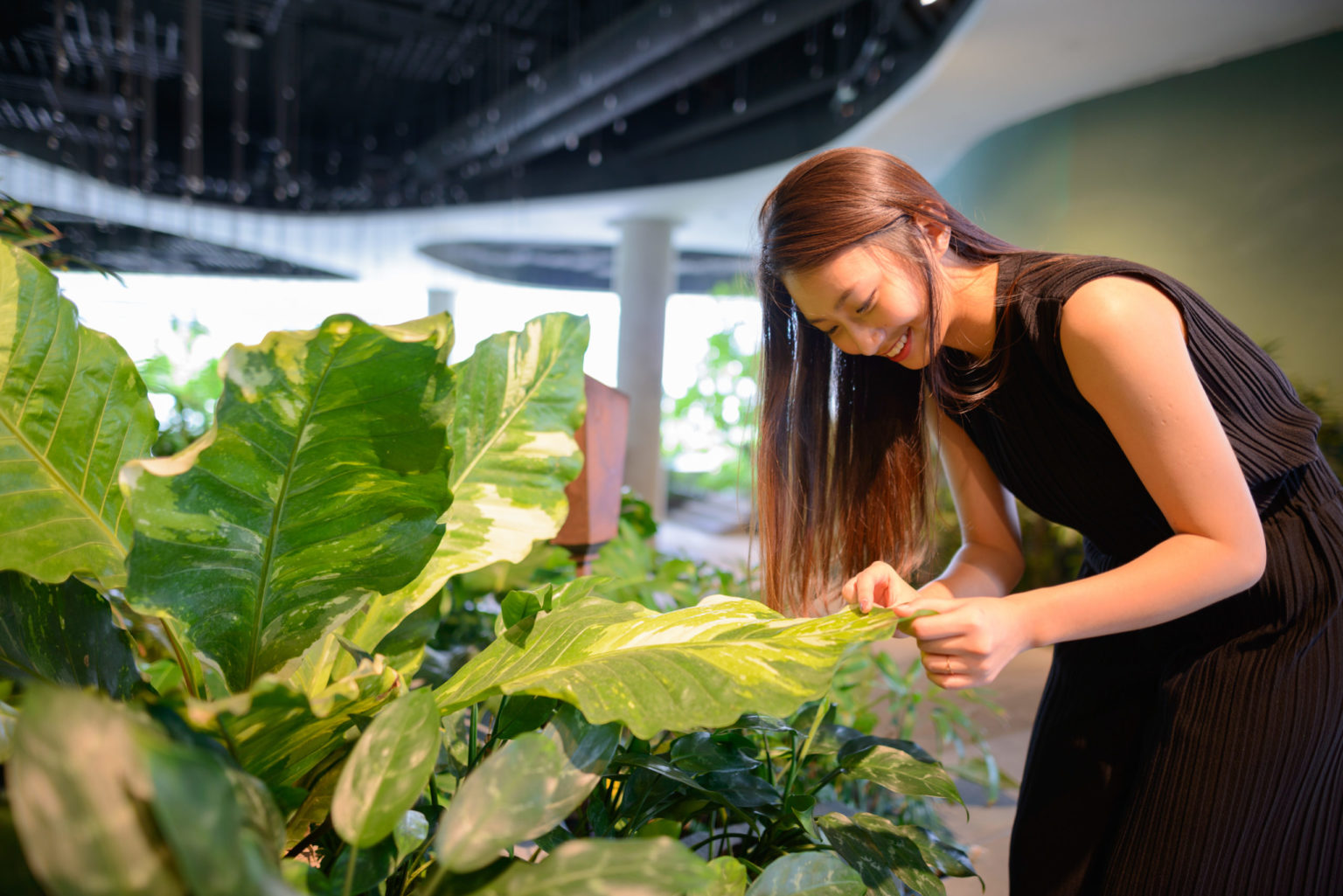 a woman looking at a large pile of lettuce