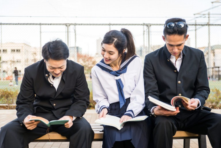 a few business people sitting on a bench