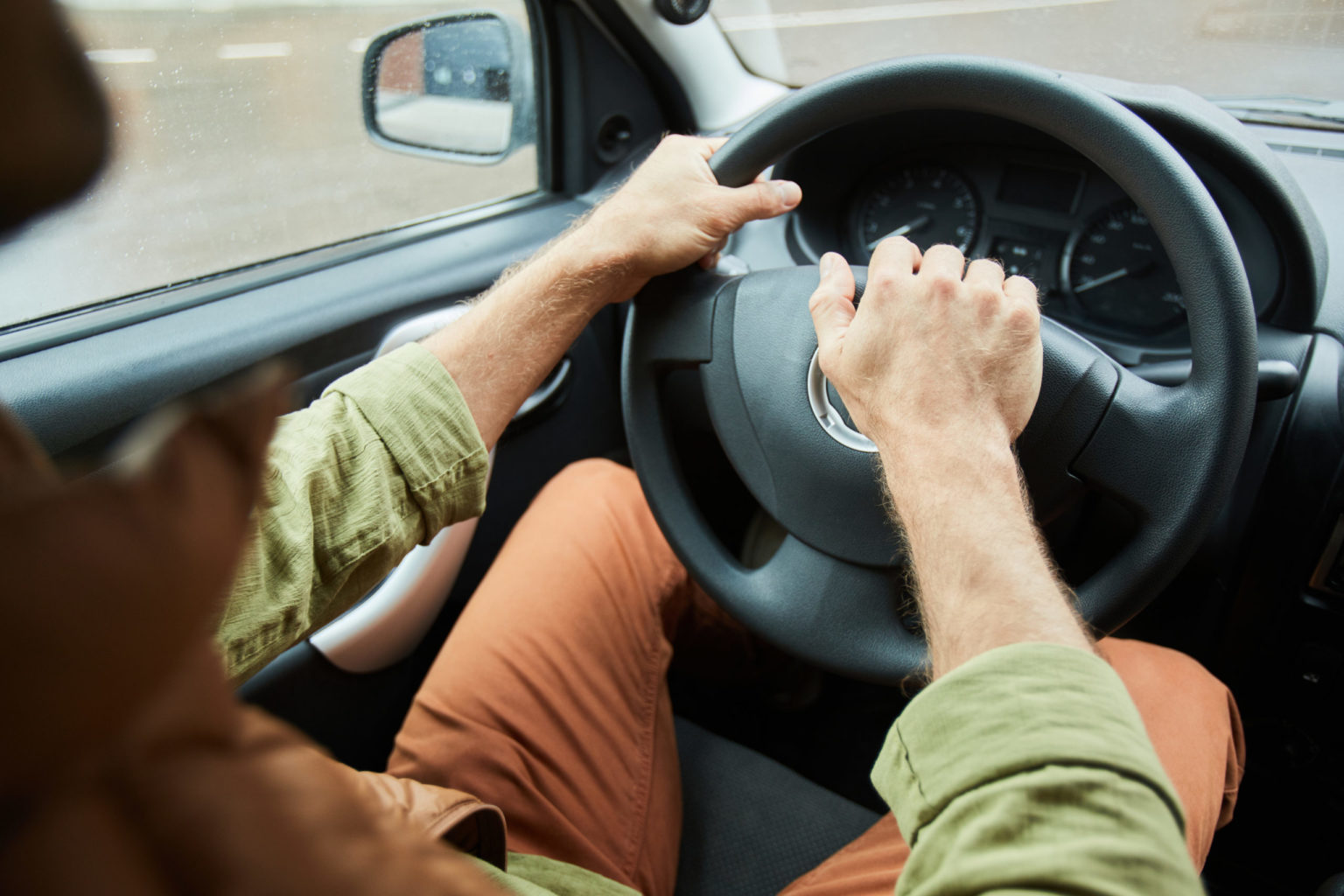 a person in a car holding a piece of food