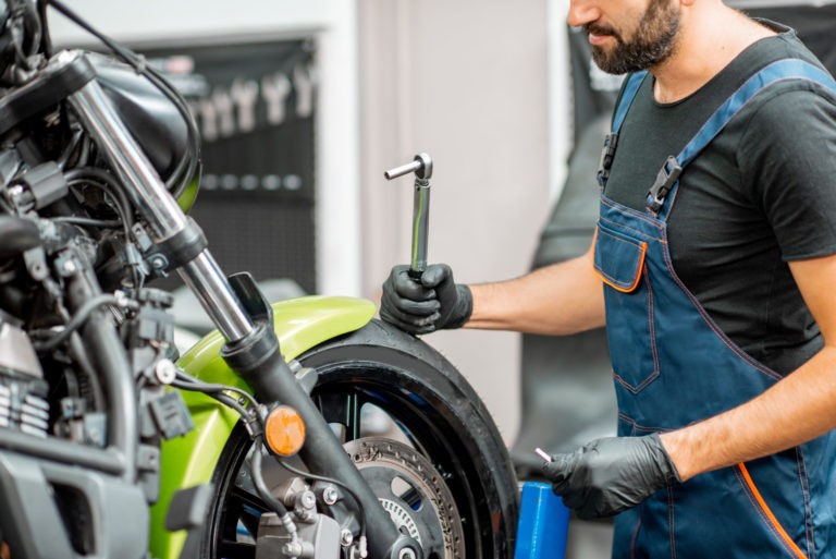 a man working on a motorcycle