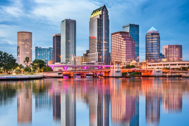 a body of water with buildings in the background