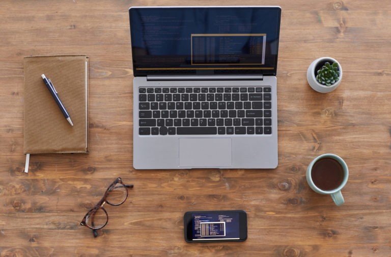 a laptop and a cup of coffee