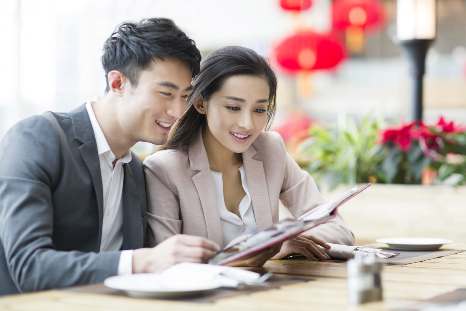 a man and a woman looking at a tablet