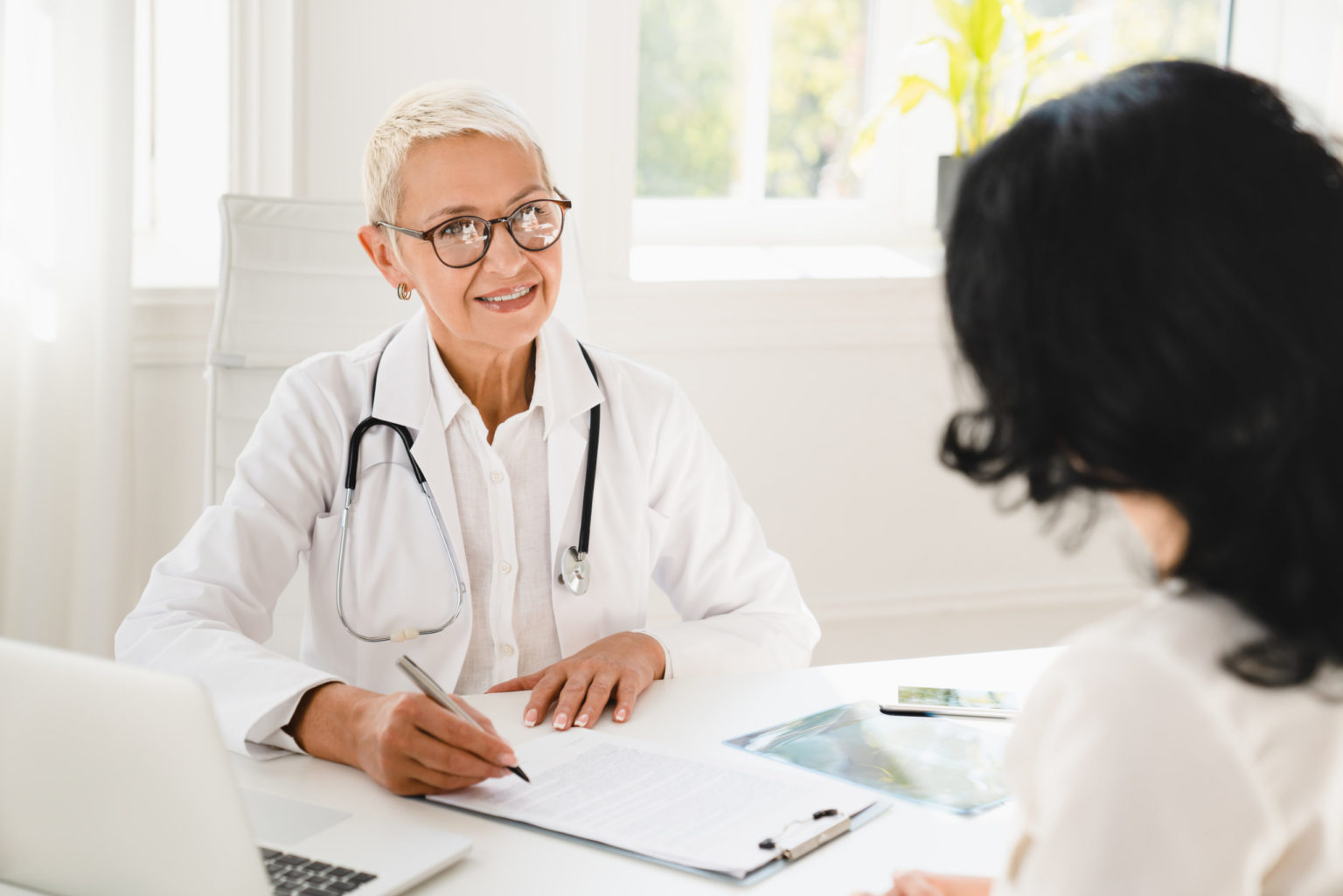 women talking to doctor